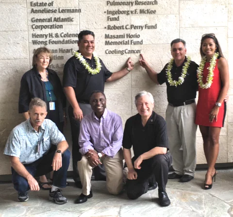 Cooling Cancer supporters beside the Cancer Center donor wall in 2015